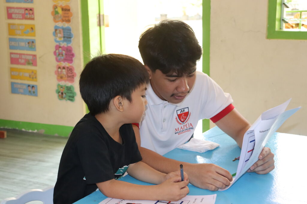 Volunteer tutoring a child one-on-one