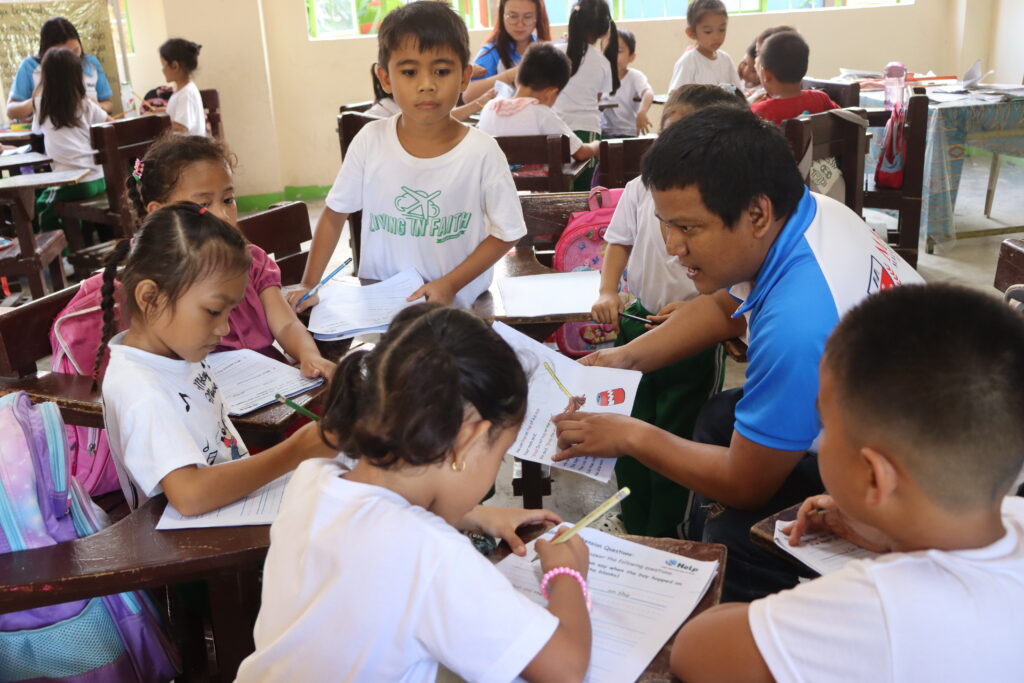 Volunteer helping a student write answers
