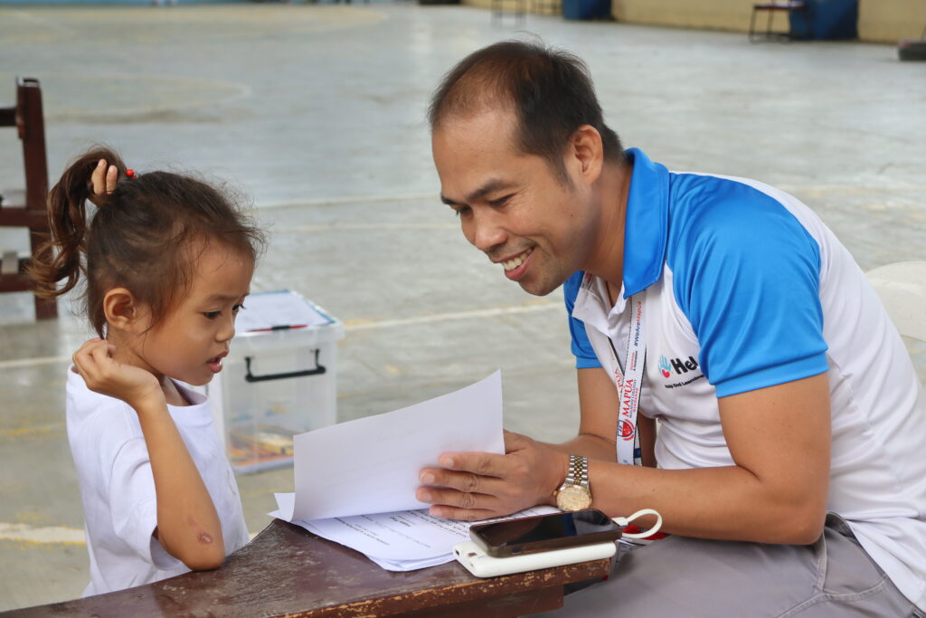 Volunteer assisting a young learner