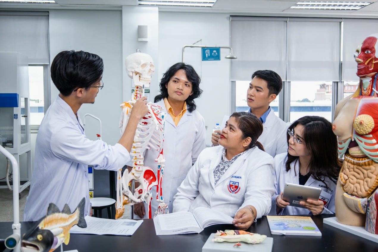 Students using models to understand biological concepts at laboratory