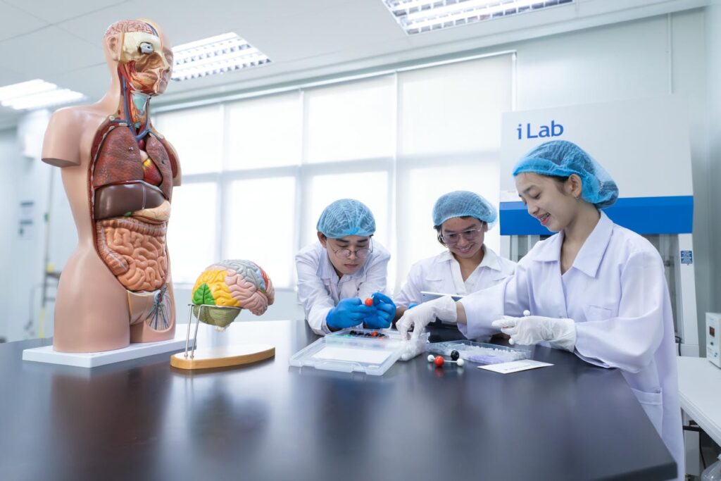 Students in lab recording findings on experiments