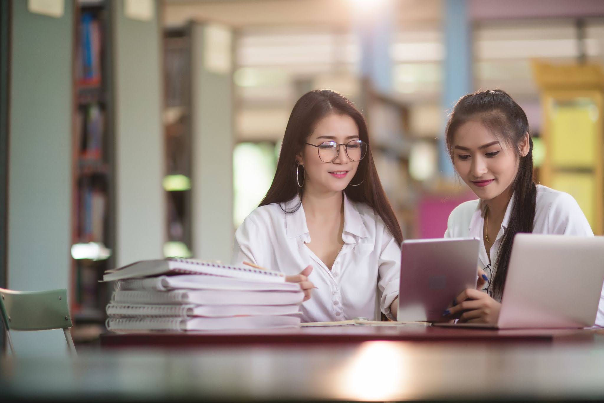 Young female students learning in a library | Mapúa Malayan Colleges Mindanao Young female students learning in a library
