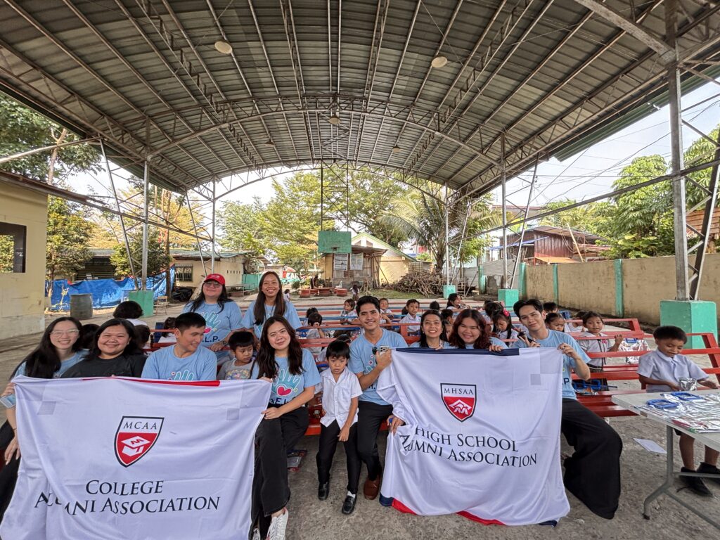 Officers of the Mapúa MCM College and High School Alumni Associations with Grade 1 learners of Carmen Integrated School during the Launching of alumni-led Program H.E.L.P.