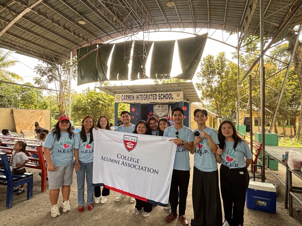 Officers and volunteers of the Mapúa MCM College Alumni Association gather at Carmen Integrated School in support of the alumni-led Program H.E.L.P. and its 55 Grade 1 beneficiaries.